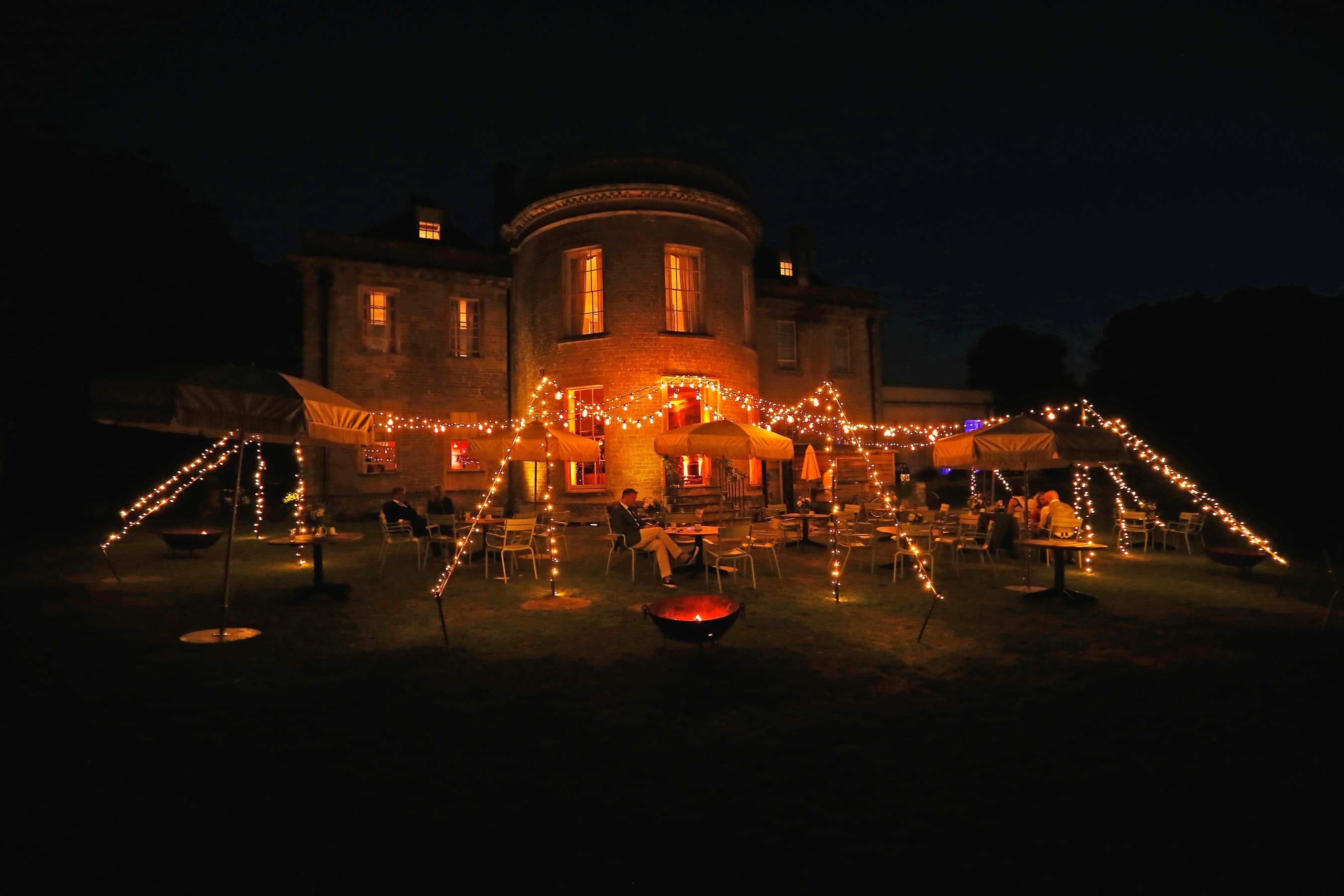 Chill Out Camp with vintage Edison festoon lighting and fairy lights creating a magical outdoor party atmosphere
