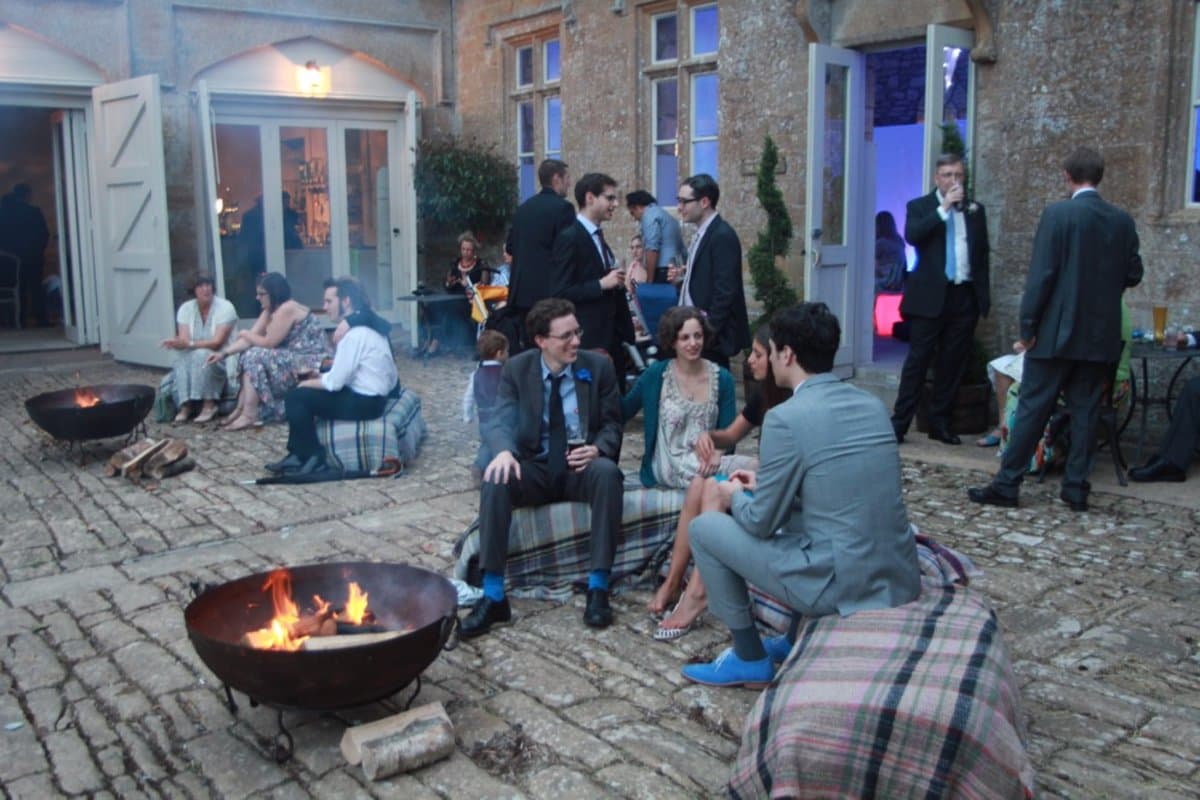 Fire pit hire for weddings — guests gathered outdoors at a manor house