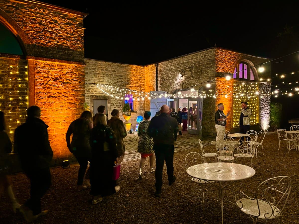 Pennard House wedding with amber LED uplighting highlighting architectural features