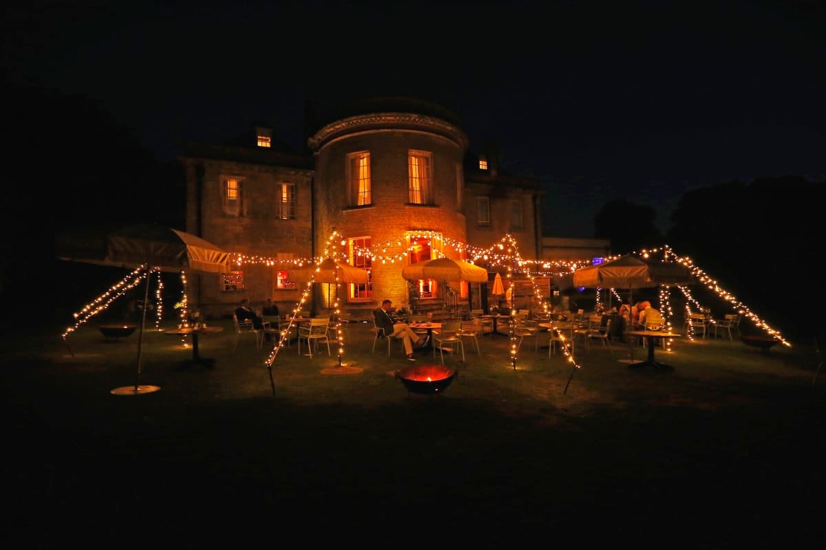 Chill Out Camp with vintage Edison festoon lighting and fairy lights creating a magical wedding atmosphere