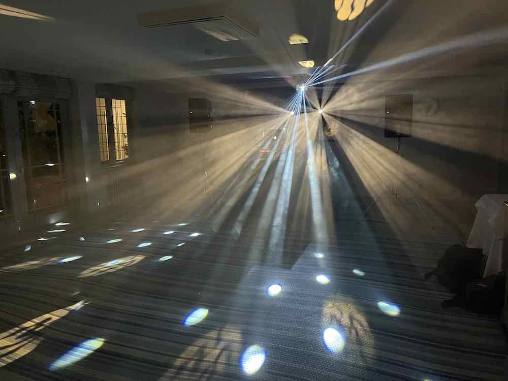 DJ Nige with white dancefloor lighting and a busy wedding party