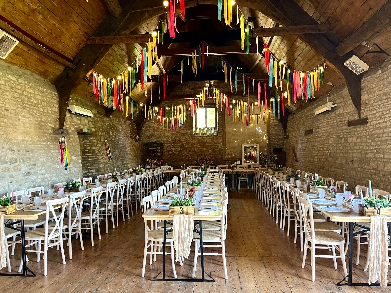 Ribbon garlands and festoon lighting create a colourful and fun addition to Mells Barn