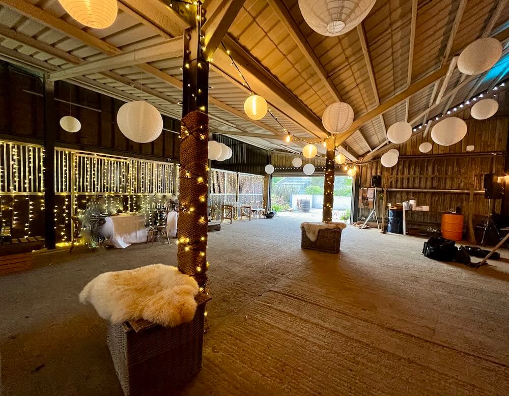 Venue after transformation - elegant outdoor terrace with professional venue styling, festoon lighting and beautiful decorations