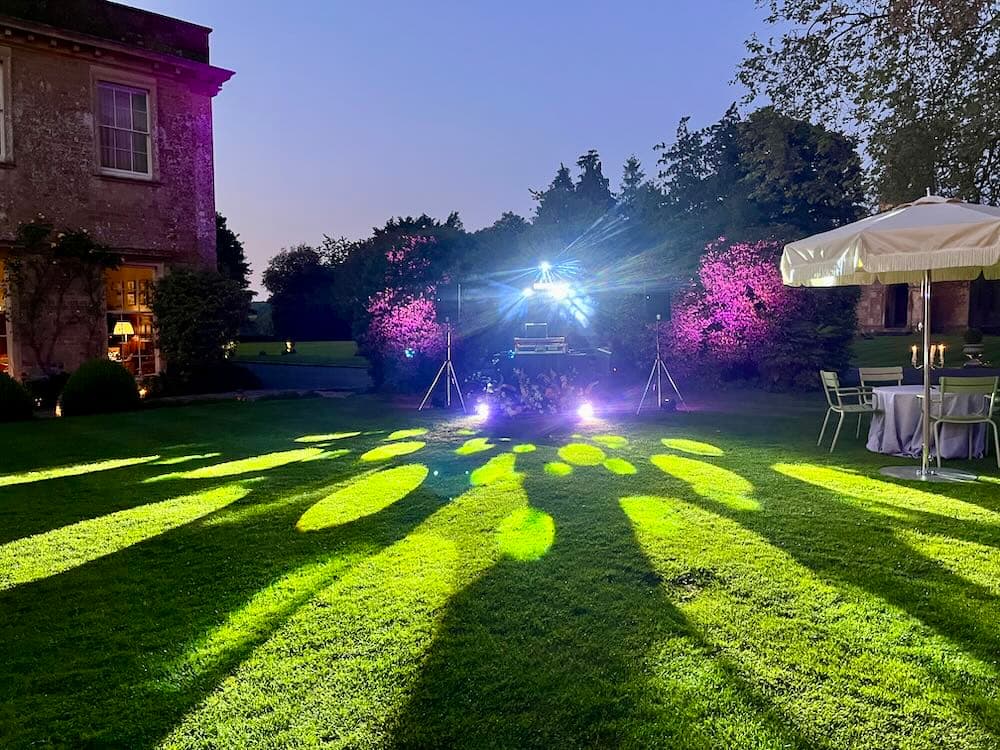 DJ kit set up on a croquet lawn with party lighting ready for an outdoor celebration