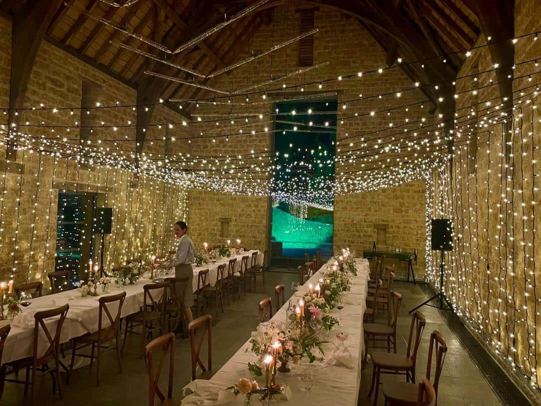 The Newt Somerset wedding venue with fairy light tunnel installation showcasing professional wedding lighting design and venue transformation