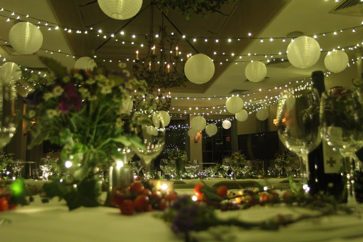 Fairy light canopy with shades creating a romantic wedding atmosphere with elegant lighting design