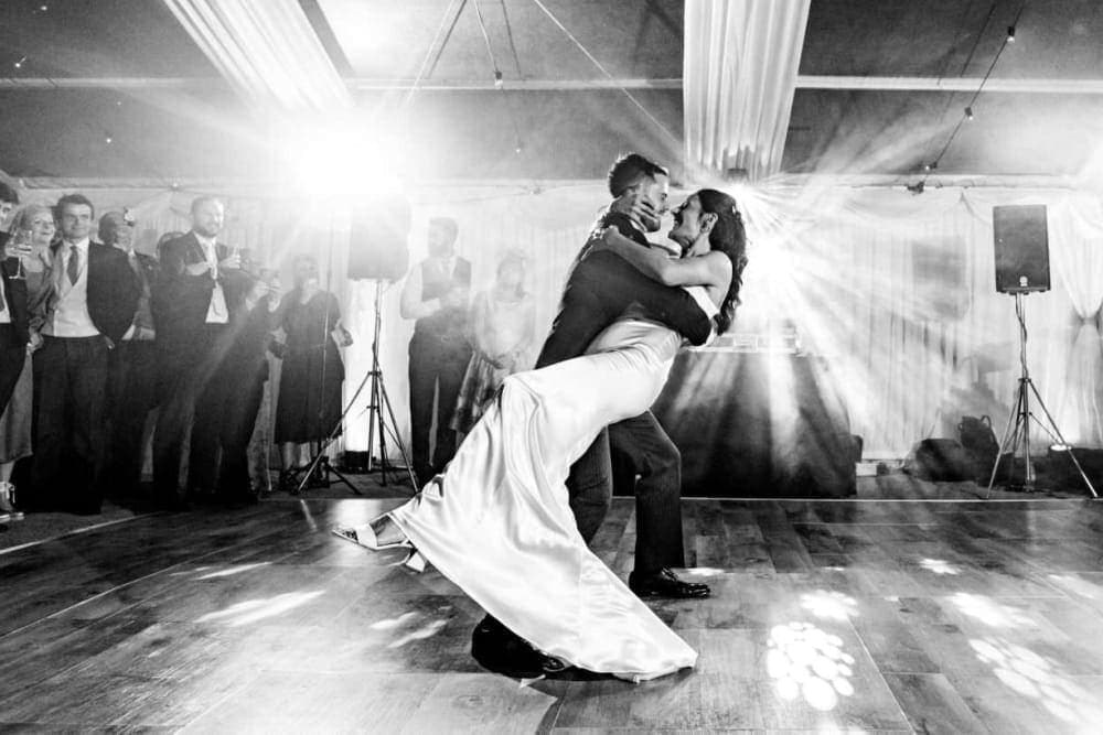 Emily and Tom's wedding reception with stunning atmospheric lighting design, captured by Jonny Barratt Photography, creating a magical evening ambiance