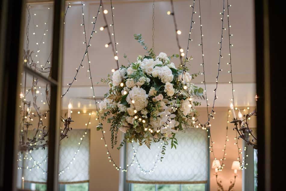 Orangery venue with elegant lighting design creating a sophisticated daytime and evening atmosphere